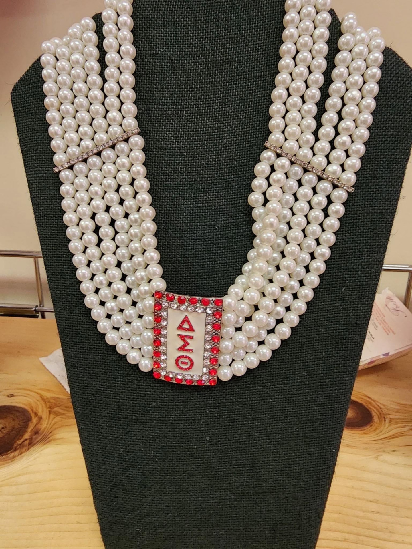 Multi-strand white pearl collar necklace with a rectangular crystal and crimson ΔΣΘ plate pendant