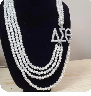Four-strand pearl necklace with a jeweled ΔΣΘ side centerpiece