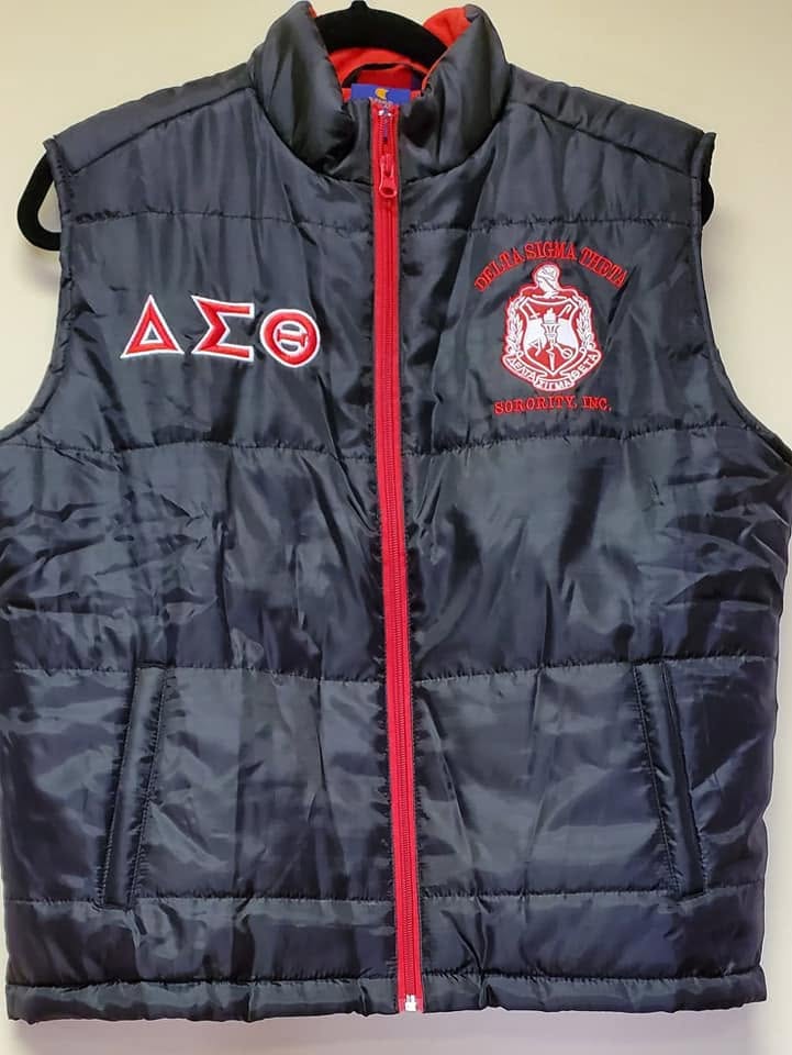 Black Delta Sigma Theta puffer vest with red zipper, Greek lettering, and embroidered Sorority crest