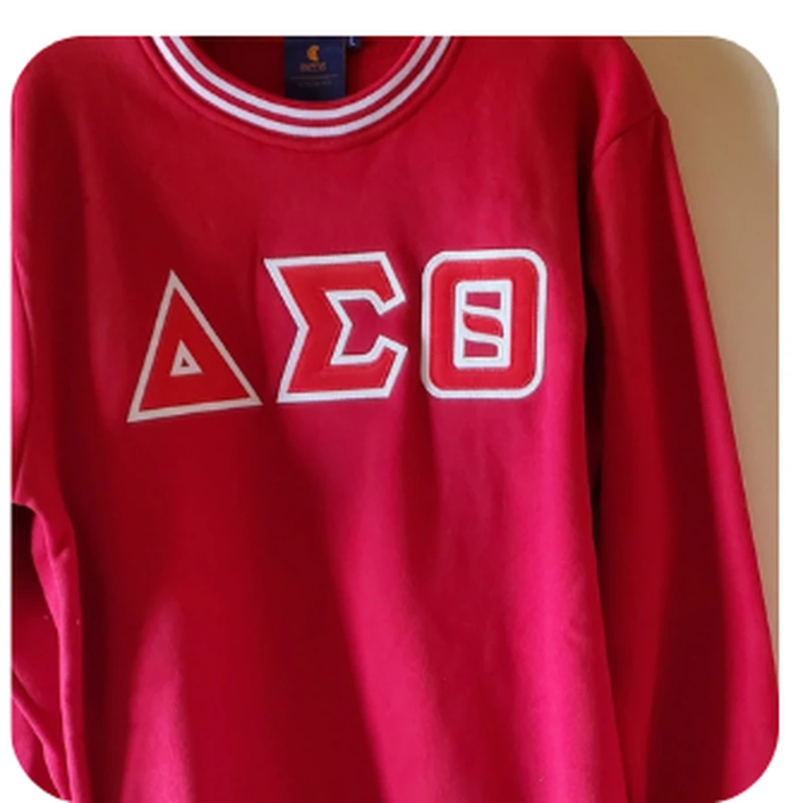 Crimson crewneck sweatshirt with white sleeves, DST letters and crest