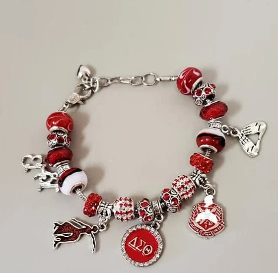 Silver charm bracelet with red and white beads, ΔΣΘ disc, crest and elephant charms