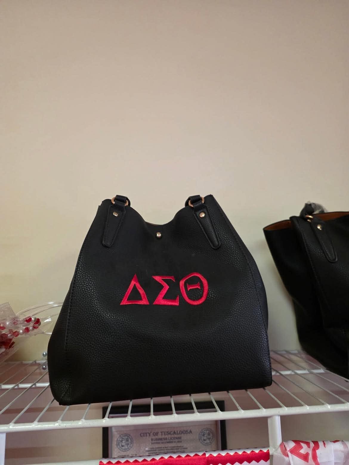 Black pebble-stone shoulder bag with crimson Delta Sigma Theta embroidery