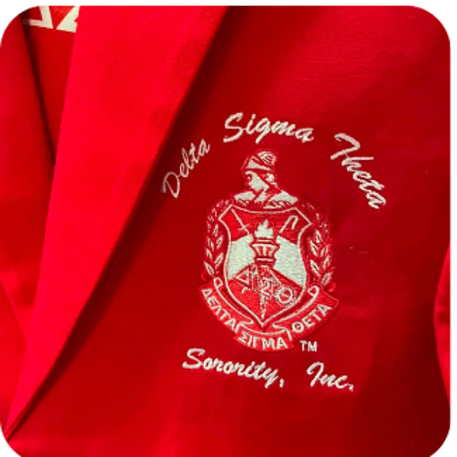 Close-up of the embroidered DST crest inside the red blazer