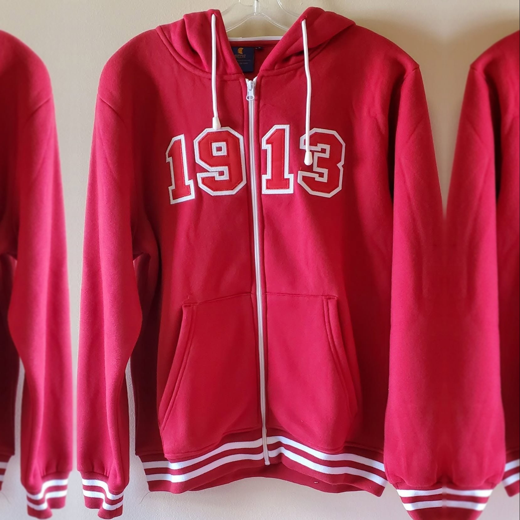 Crimson 1913 full-zip hooded sweat jacket on a hanger